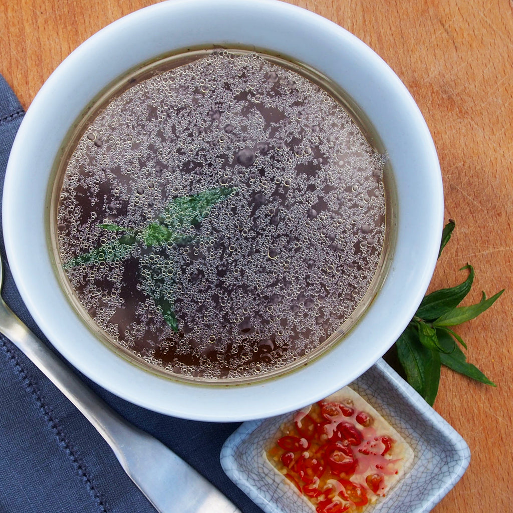 A bowl of Lara's Beef Bone Broth, featuring a rich and savory broth with a deep, inviting color, perfect for adding depth and flavour to your culinary creations.