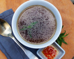 A bowl of Lara's Pho Beef Bone Broth, featuring a rich and flavorful broth infused with aromatic spices and tender pieces of beef, creating a delightful and savory dish.