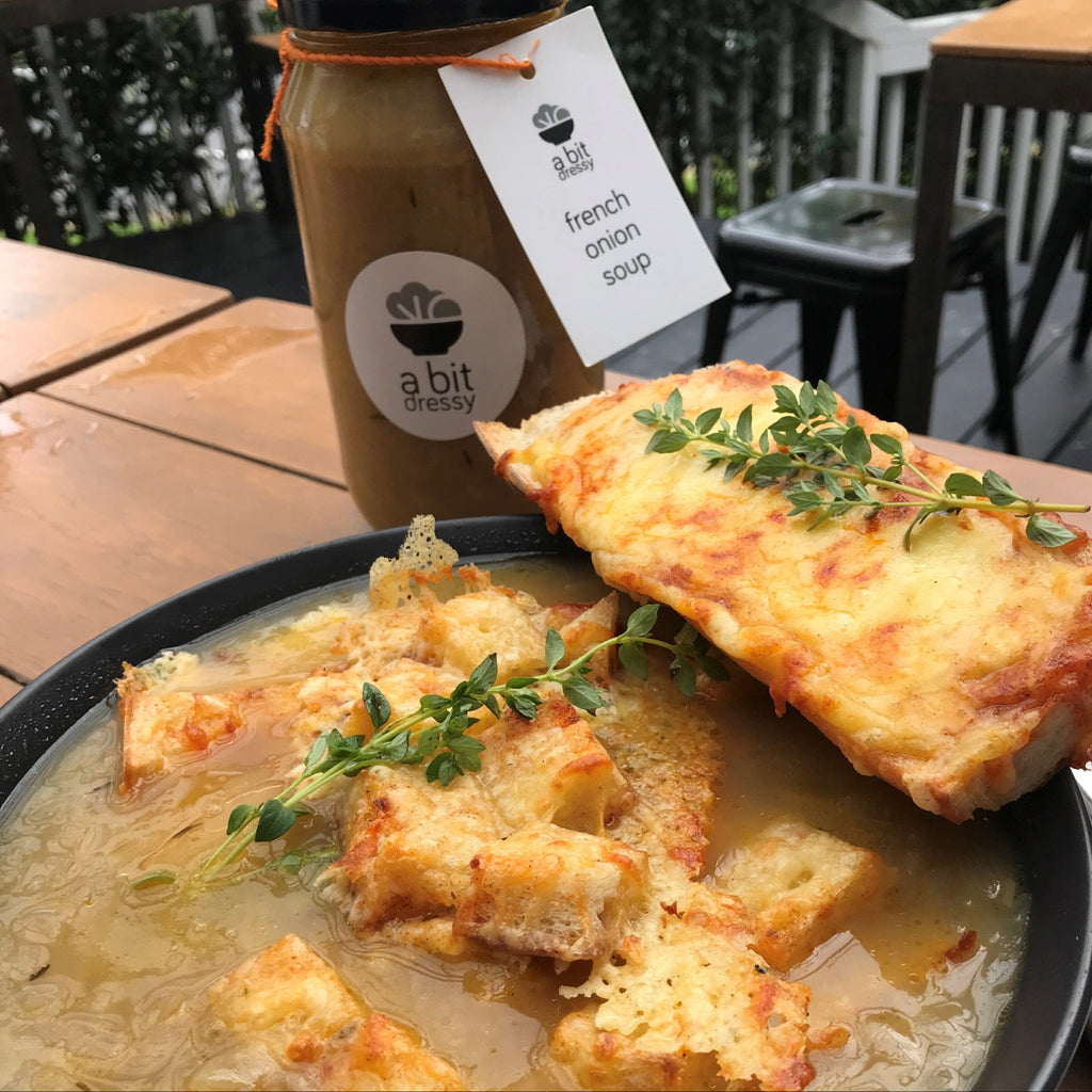 Jar of French onion soup with a bit dressy label on a wooden surface