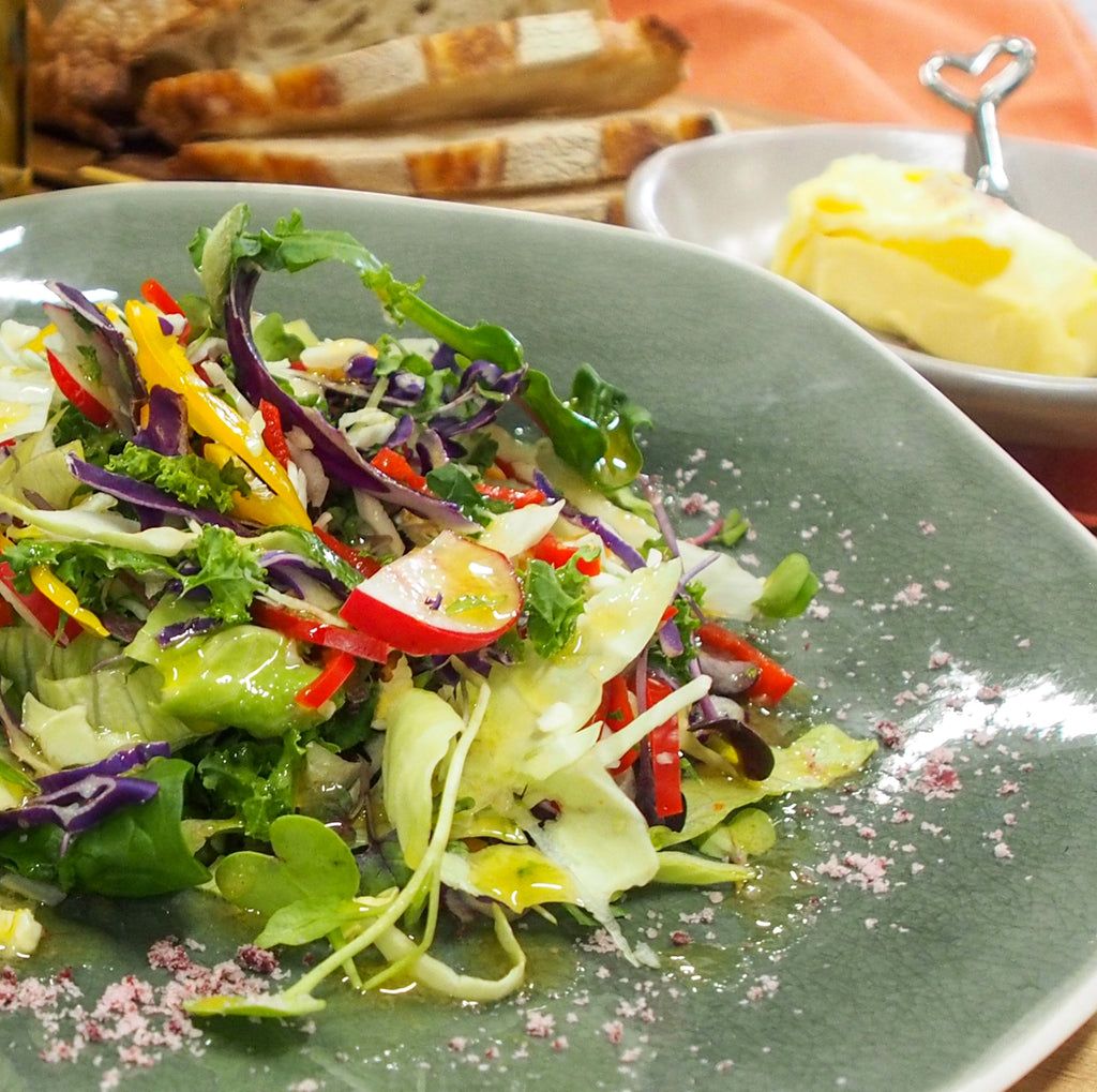 A fresh salad drizzled with Lara's Number 1 Dressing, featuring a vibrant and flavourful salad topped with a delicious dressing.