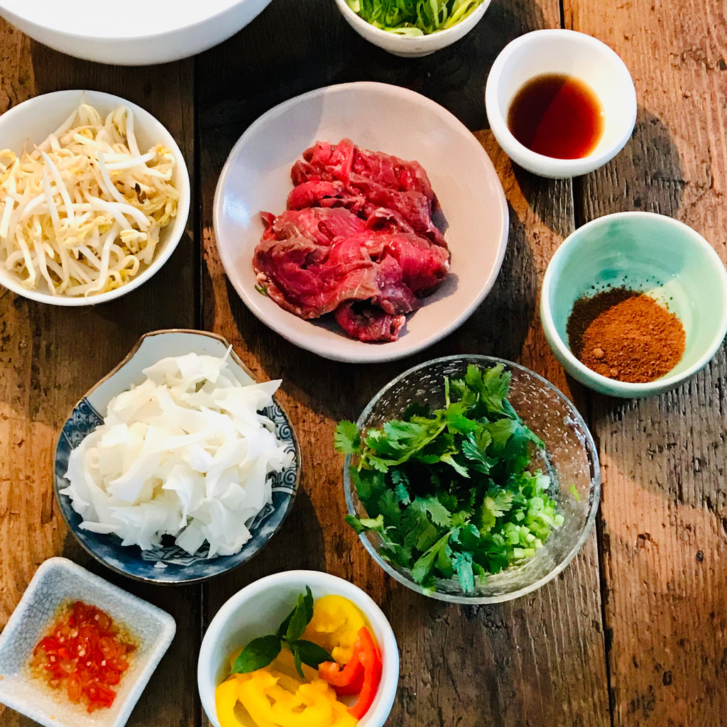 A collection of ingredients used to make beef bone broth, including beef bones, vegetables, herbs, and spices, ready for the simmering process to create a flavourful and nutritious broth