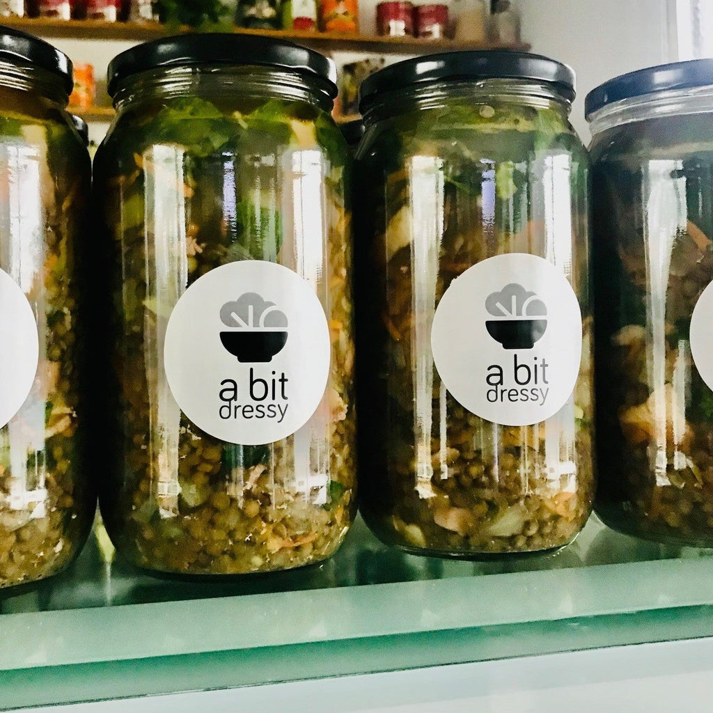 Jars of A Bit Dressy soup on a shelf in a store.