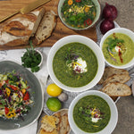 A flat lay view of several bowls of A Bit Dressy Soup, displaying a variety of delectable and flavorful soup options.