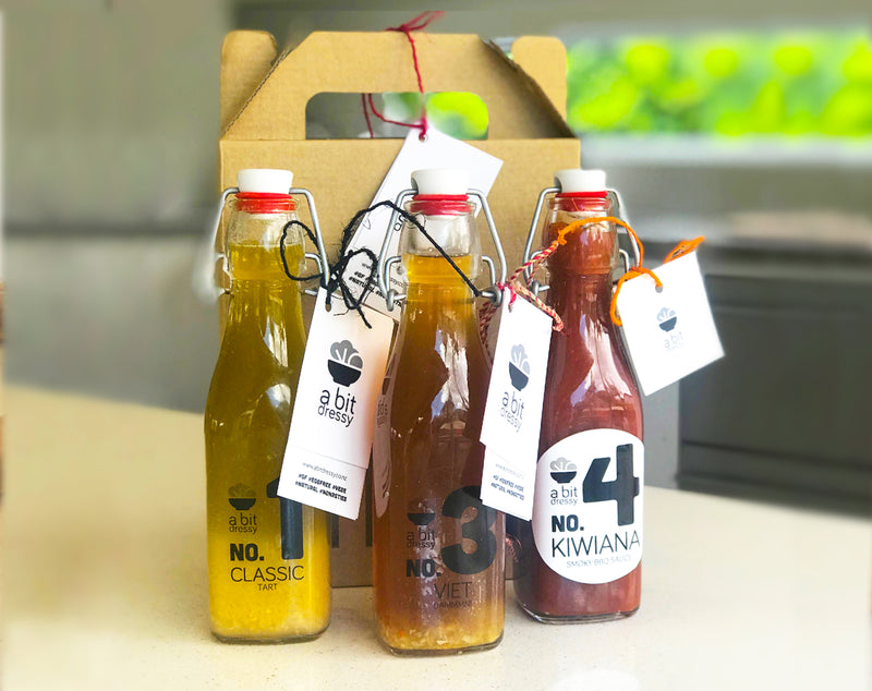 Bottles of Lara's condiments, including Kiwiana Smoky BBQ Sauce, Number 1 Tart Dressing, and Viet Dammmn Dressing, offering a flavorful selection of condiments to enhance your culinary creations.