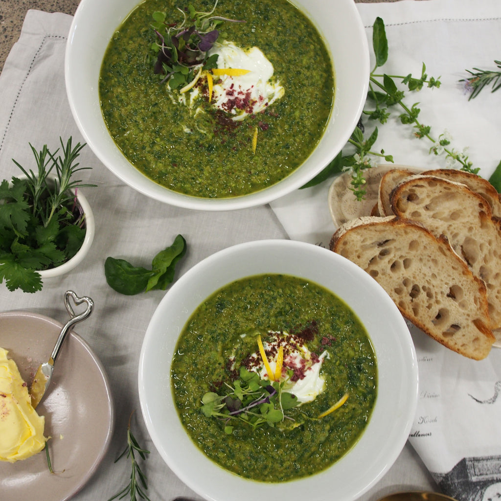 Flat lay image of a table with Green Goddess bowls, surrounded by an array of accompaniments and garnishes, creating an inviting and colorful dining scene.