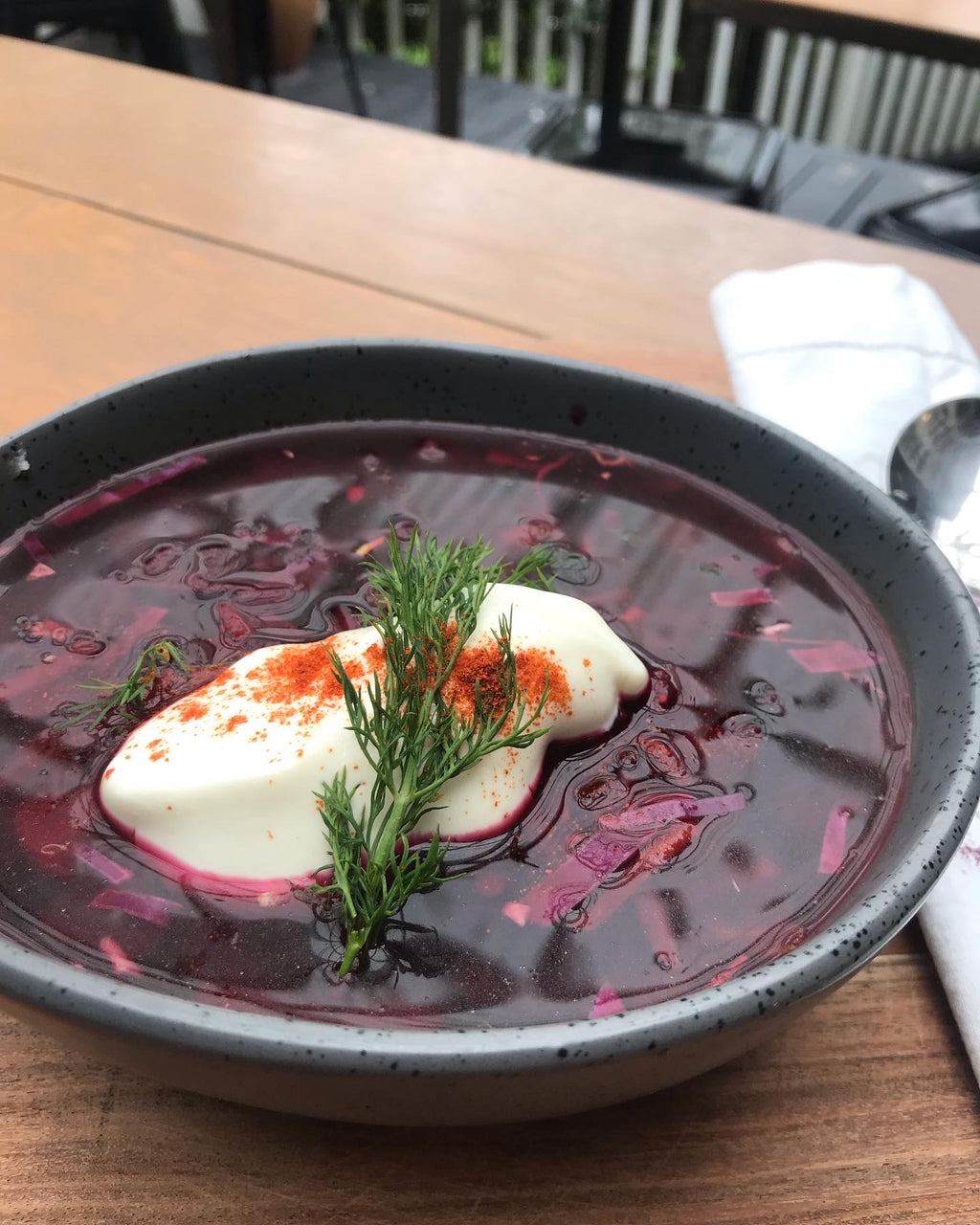 A bowl of Divine Beef Borscht with beef bone broth, featuring a hearty and flavorful traditional soup with vibrant colours and savory ingredients