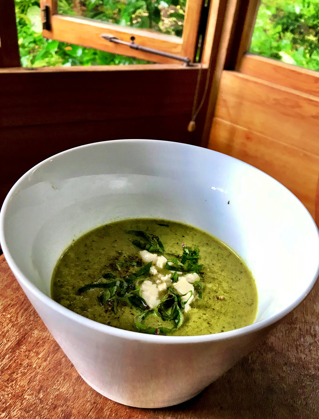 A bowl of broccoli Stilton cheese soup featuring a fragrant chicken broth and a generous serving of broccoli, enriched with the distinctive flavor of Stilton cheese