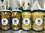 Several glass jars containing delicious soups - one jar filled with French De Puy lentil, bacon, and spinach soup, and the other with a hearty chicken soup. Each soup offers its unique flavors and ingredients.