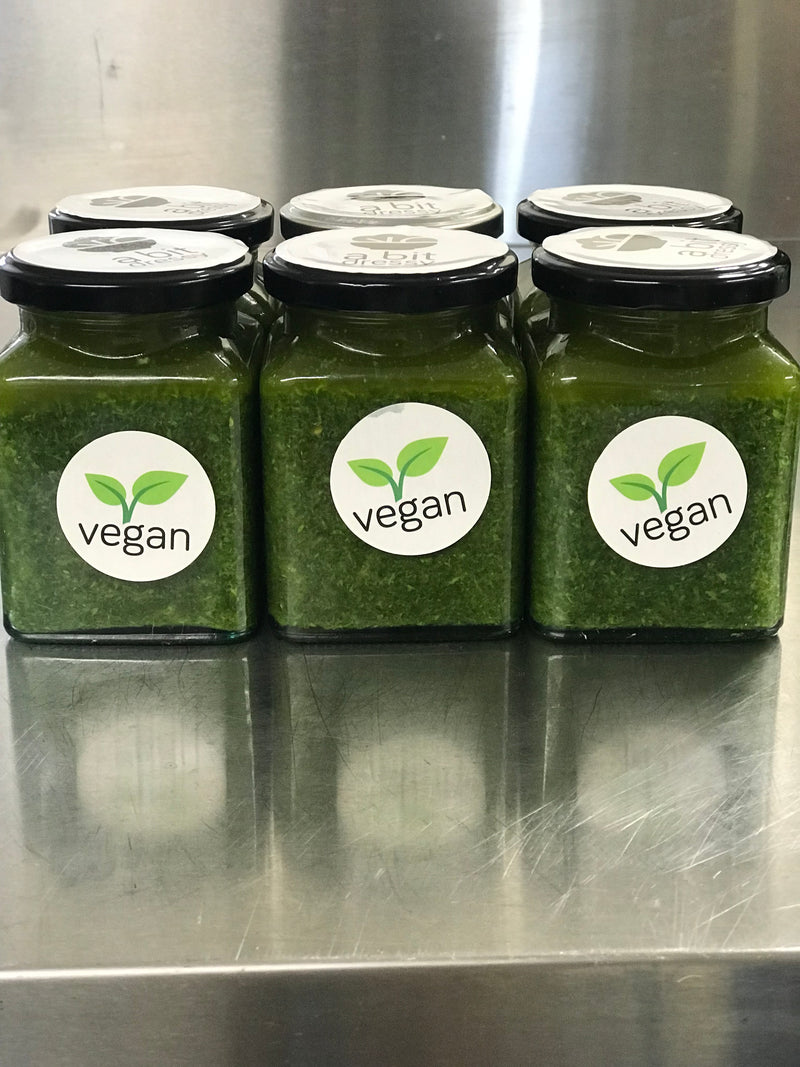 Jars filled with Lara's healthy Green Herby Sauce, a flavorful and nutritious blend of fresh herbs and seasonings, designed to enhance the taste of your dishes while promoting a health-conscious choice