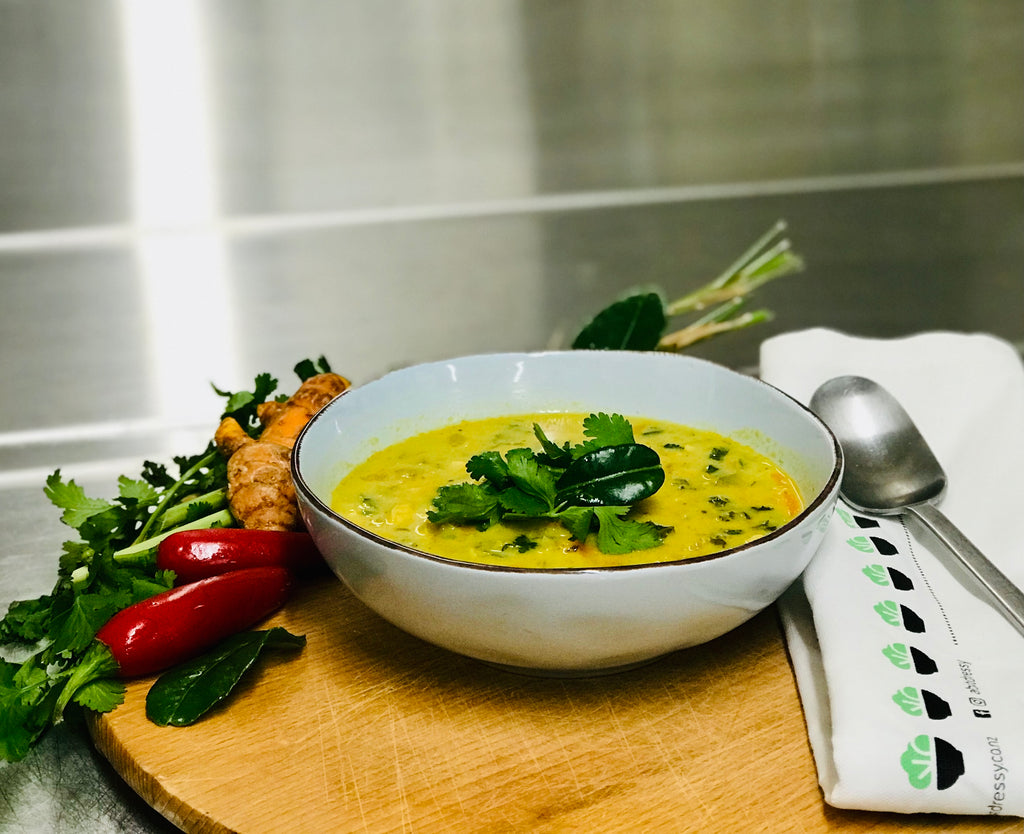 A bowl of Keto Spicy Thai Chicken Soup made with chicken broth, featuring a mouthwatering blend of ingredients, with tender chicken and Thai-inspired flavours.