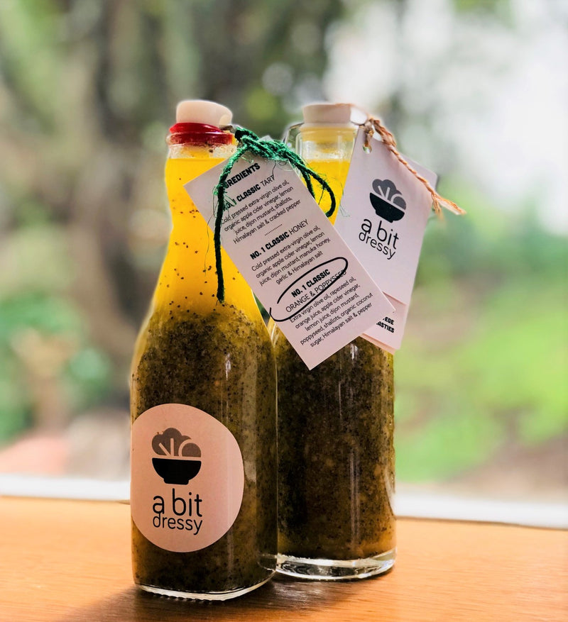 A bottle of Lara's Number 5 Classic Vegan Poppyseed and Orange Vinaigrette, a delightful and tangy dressing perfect for adding zesty flavors to your salads and dishes.