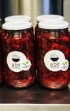 A glass jar filled with vegan borscht, featuring a vibrant, deep-red soup made from beets and other vegetables