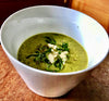 A bowl of Watercress, Kumara, and Truffle Soup, featuring a luxurious and flavorful soup with a combination of fresh ingredients and truffle essence
